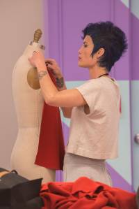 designer Emily works on her garment